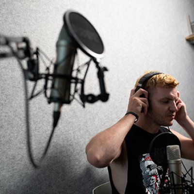 A man putting on a pair of headphones